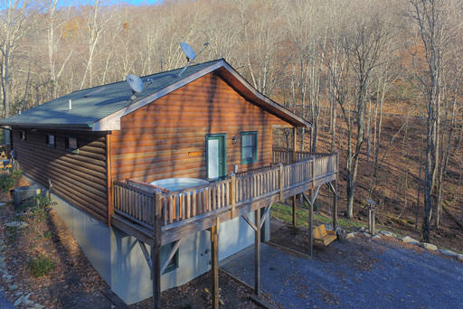 Side view of cabin and hot tub in Mountain Creek Cabin in Maggie Valley, NC